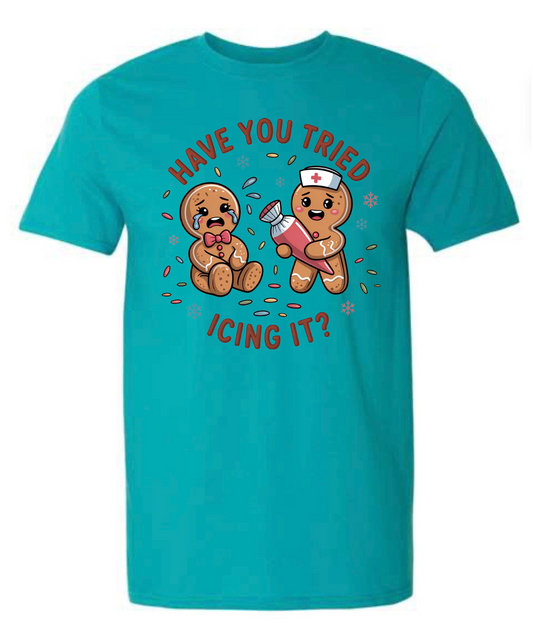 Teal t-shirt with cartoon gingerbread men and text on a white background